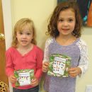 Lily and Ava stopped by to place more stickers on their charts. They'll be picking prizes soon!